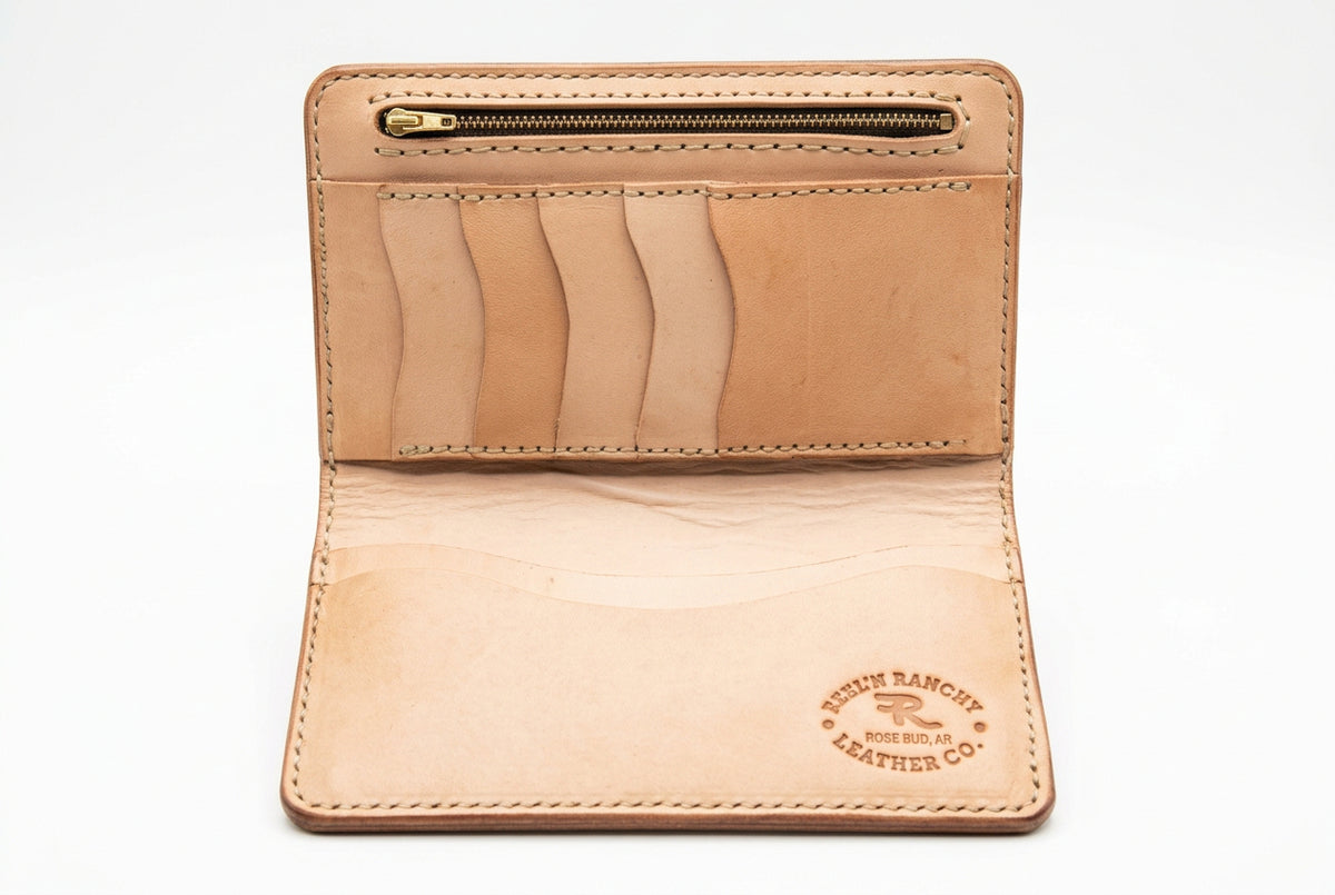 An open tan leather bifold wallet with multiple card slots.